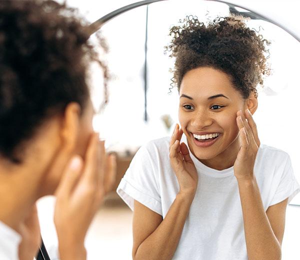 Woman looking at smile in mirror