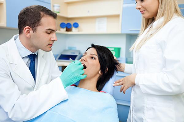 Dentist performing procedure on patient