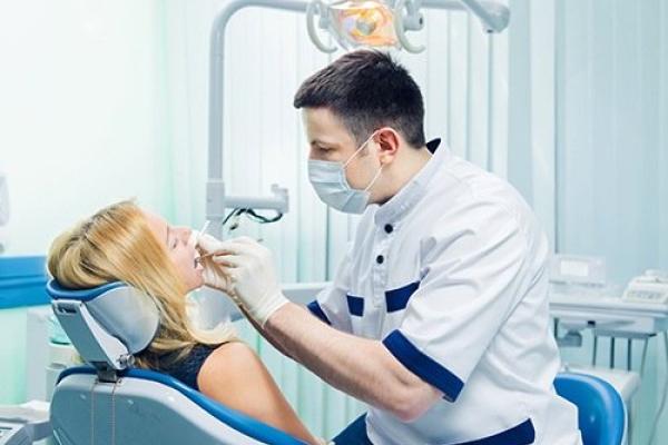 Dentist performing procedure on patient